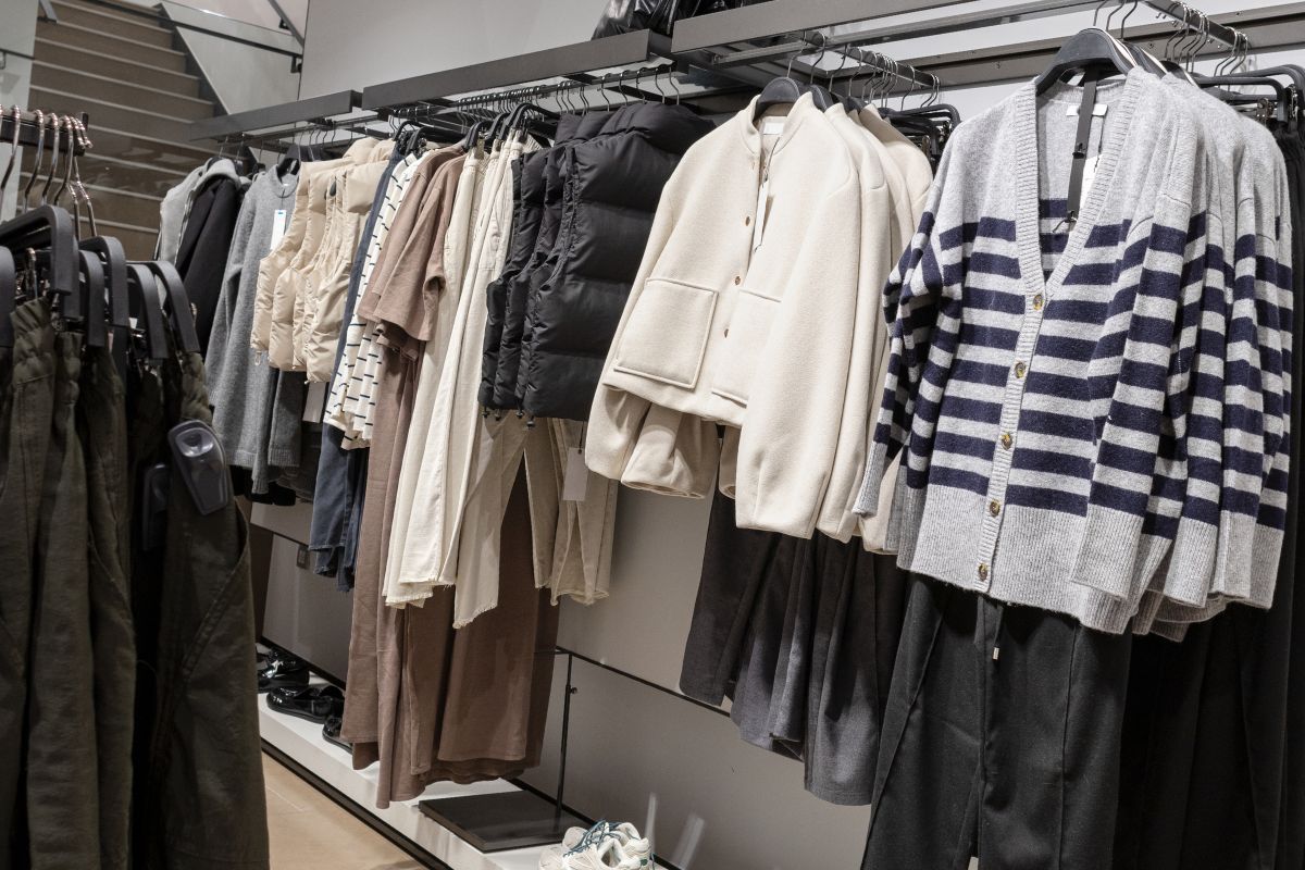 The picture of hanging brand-name clothes in the store.