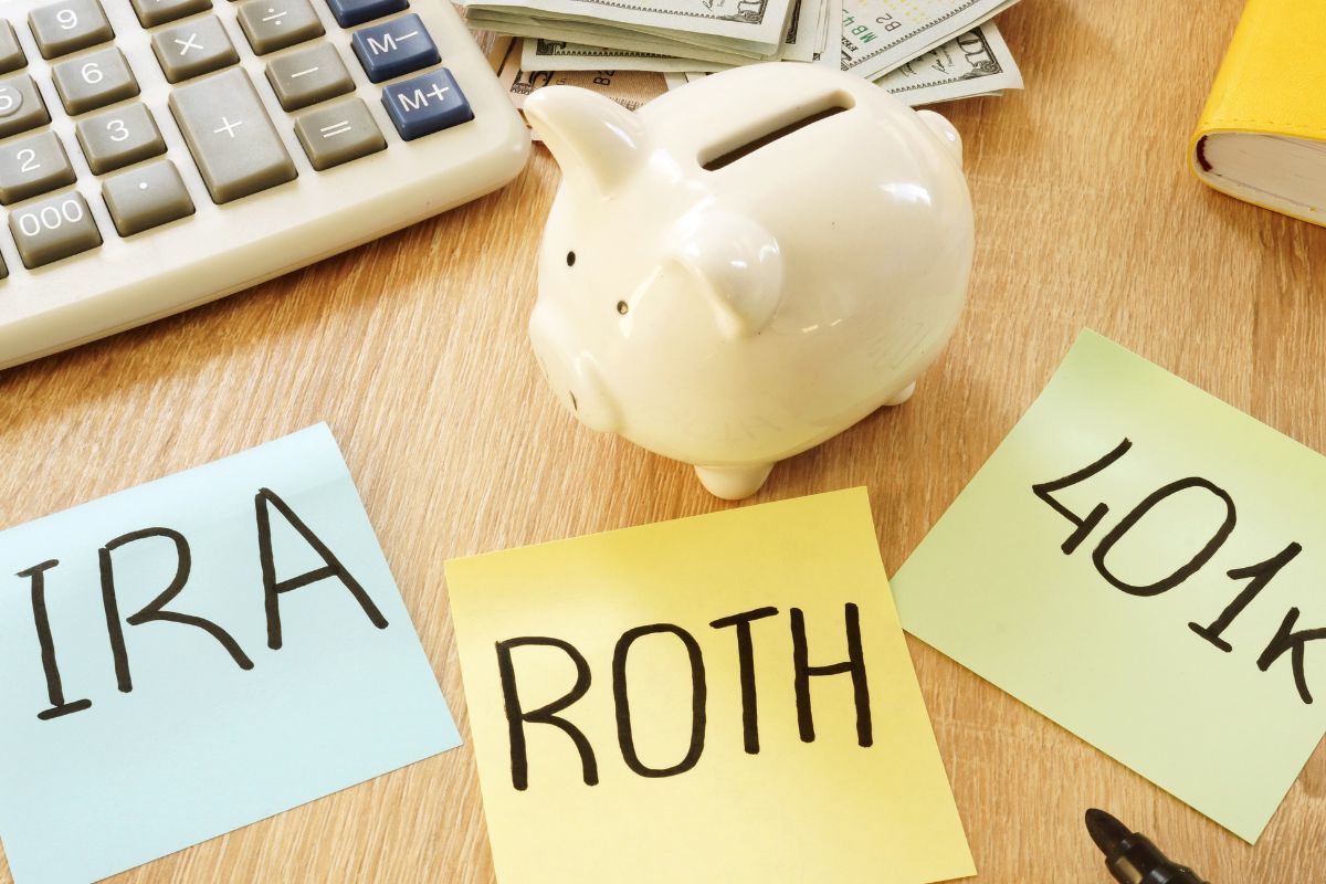 The image is about papers with wording, dollar bills, a calculator, and a piggy bank.