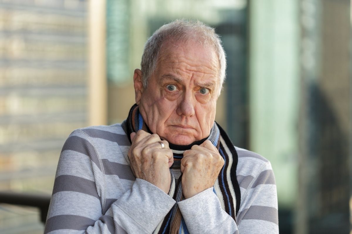 The photo of a senior man showing scared reaction.