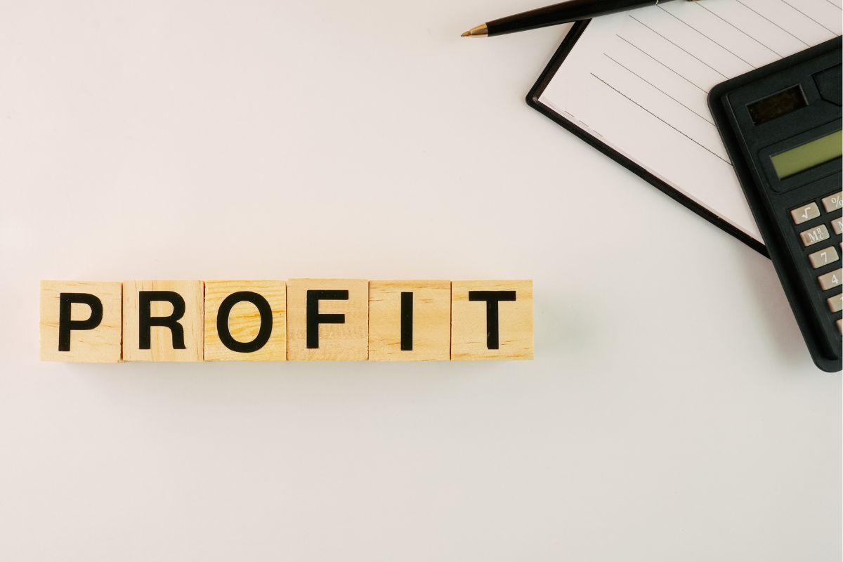 The photo of wooden cubes with profit combined letters and budgeting tools.