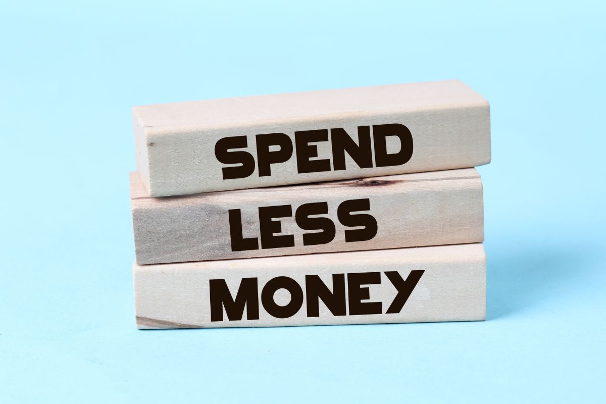 The picture of wooden rectangles with Spend Less Money notes.