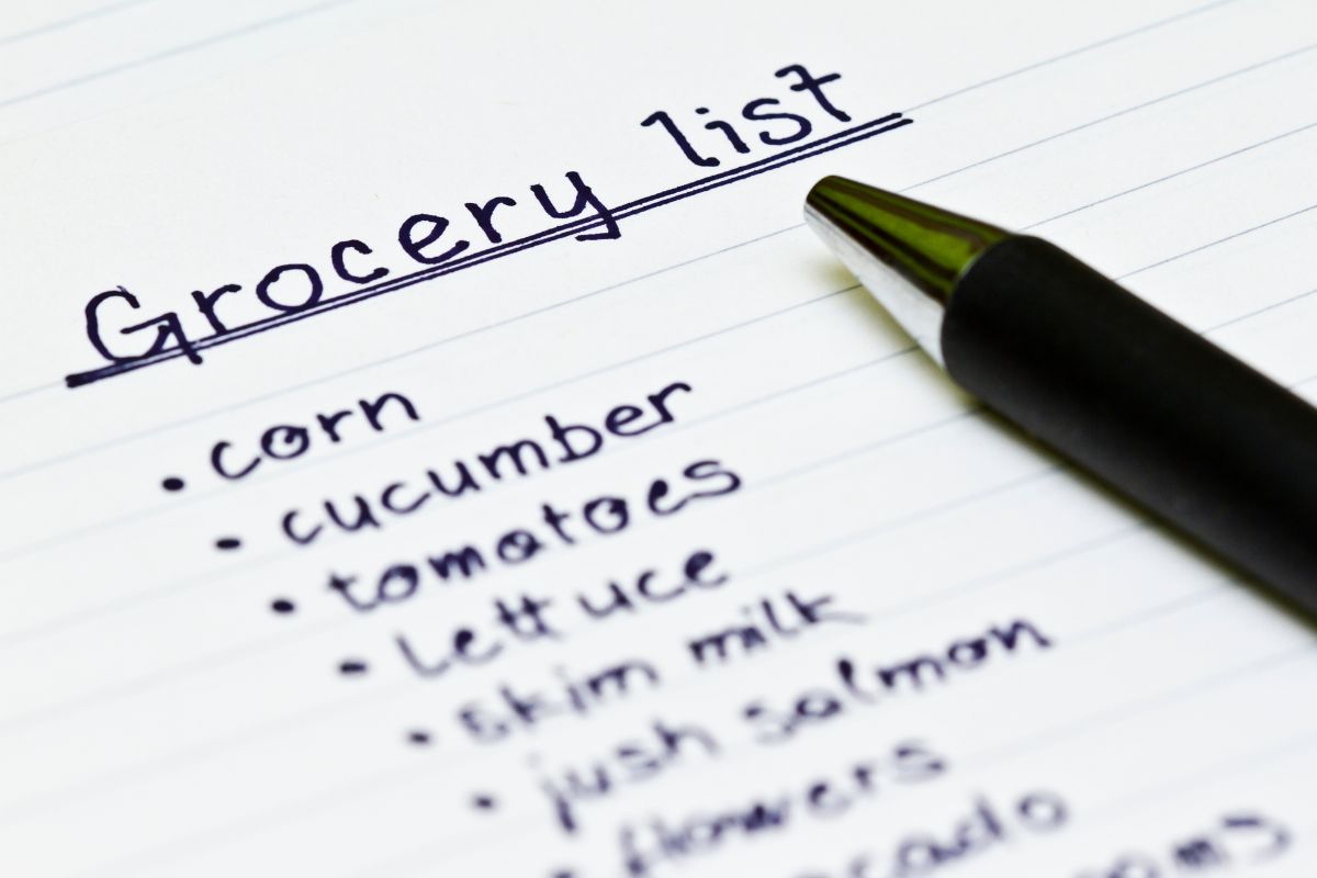 The picture is about a pen and paper with a grocery list.