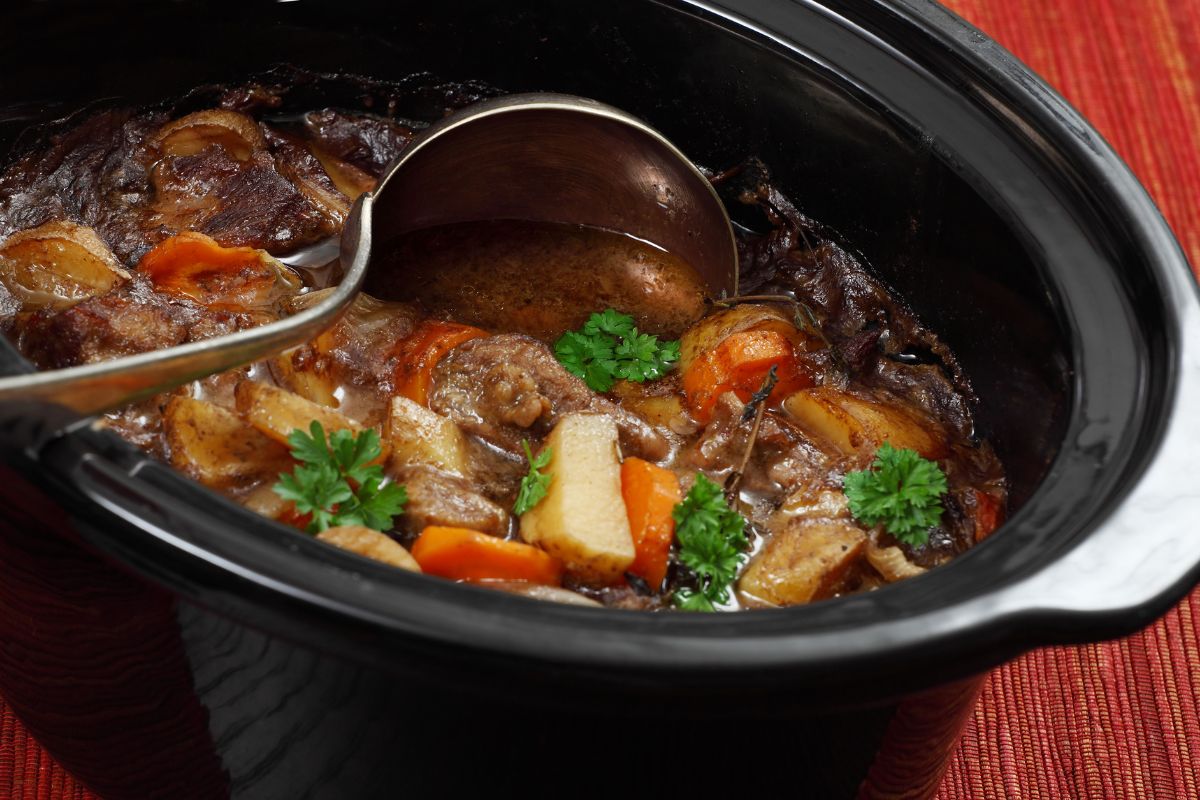 The image is about a slow cooker with a meal.