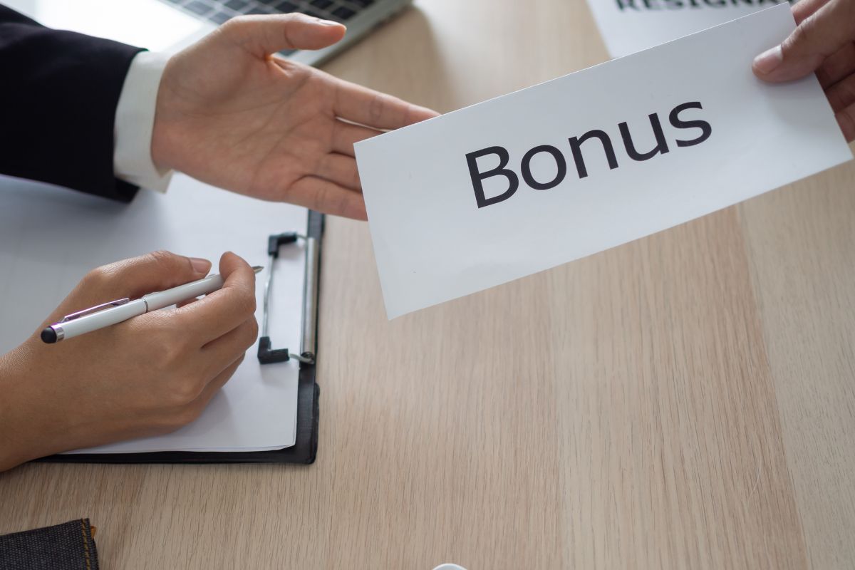 The picture shows a man handing a bonus to the employee.