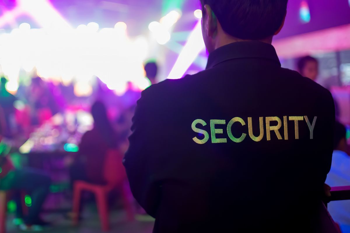 The picture of a security man on duty in a bar.