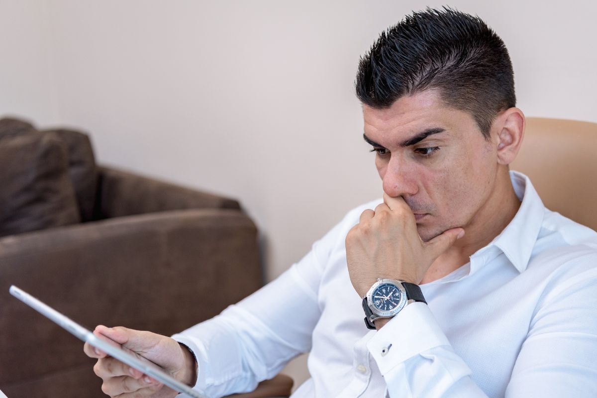 A picture of someone looking at their gadget. 