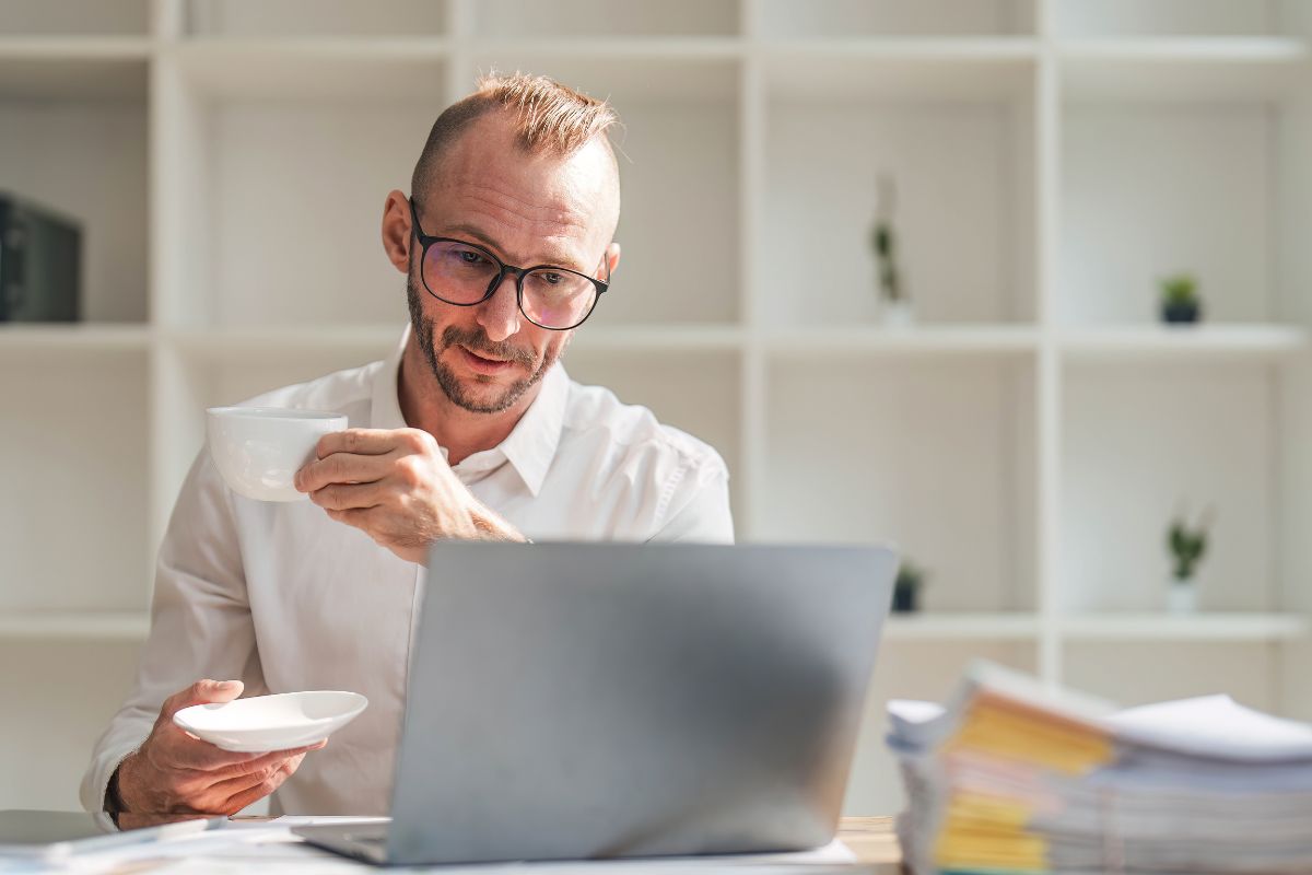 A picture of someone looking at their laptop. 