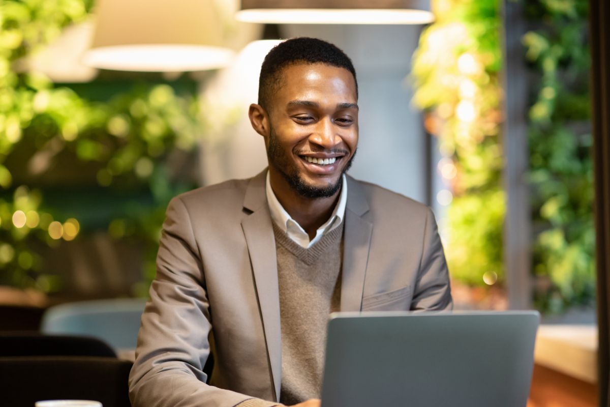 A picture of someone looking at their laptop. 