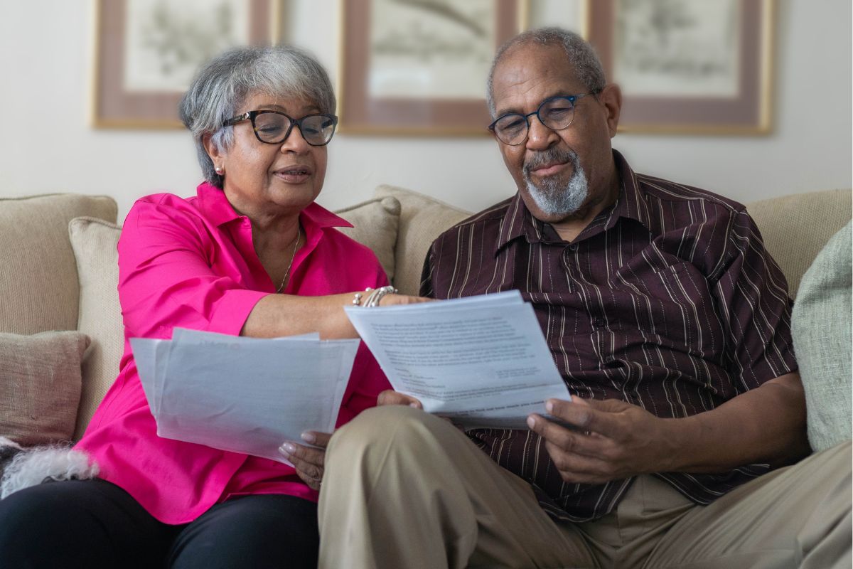 A picture of old people reviewing documents. 
