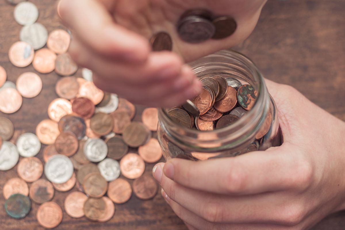 A picture of a jar with cents and pennies. 