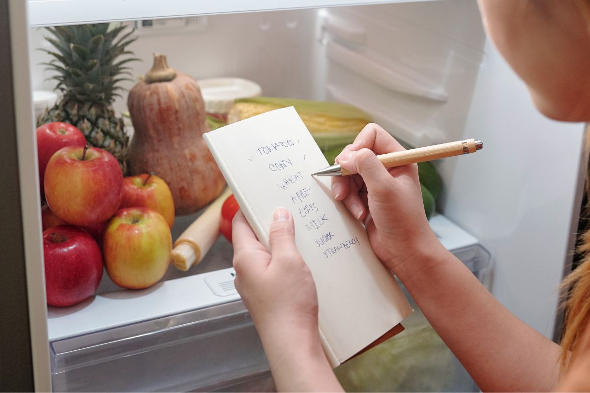 A picture of someone making a grocery list. 