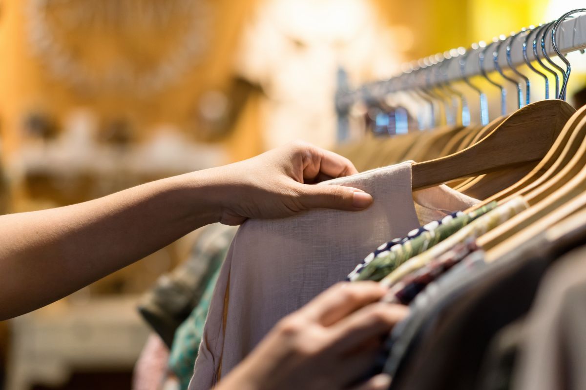 A picture of someone doing thrift shopping. 