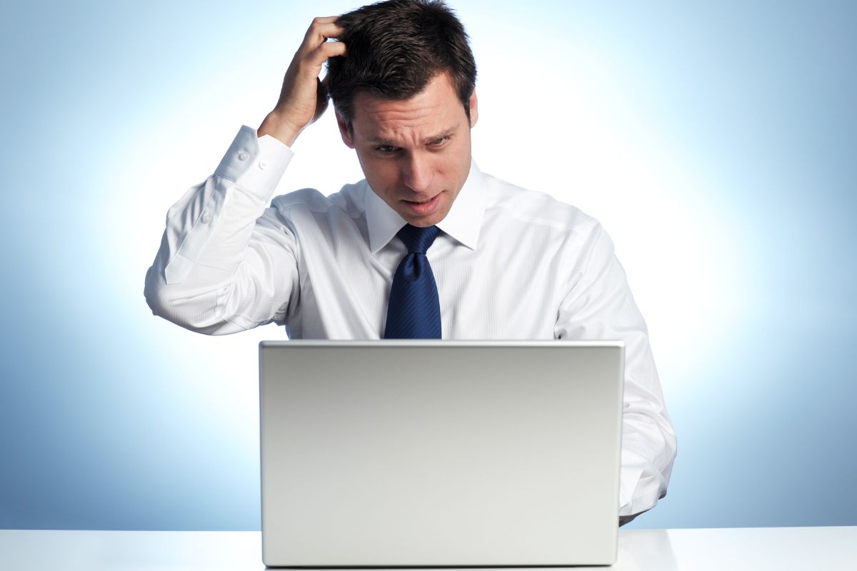 A picture of someone scratching their head. 