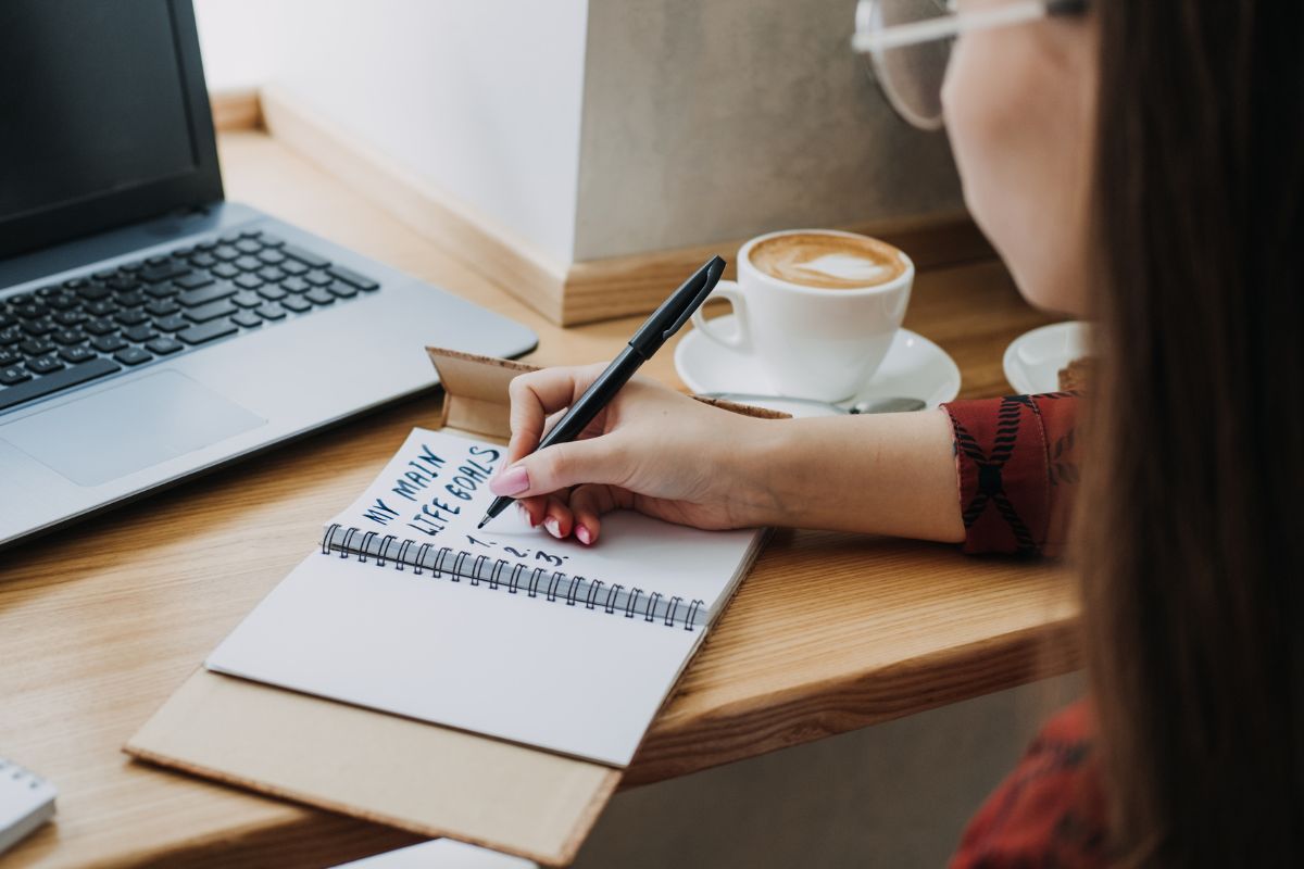 A picture of someone writing down their goals.
