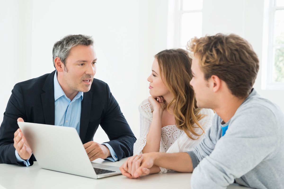 A picture of a couple with a financial advisor. 