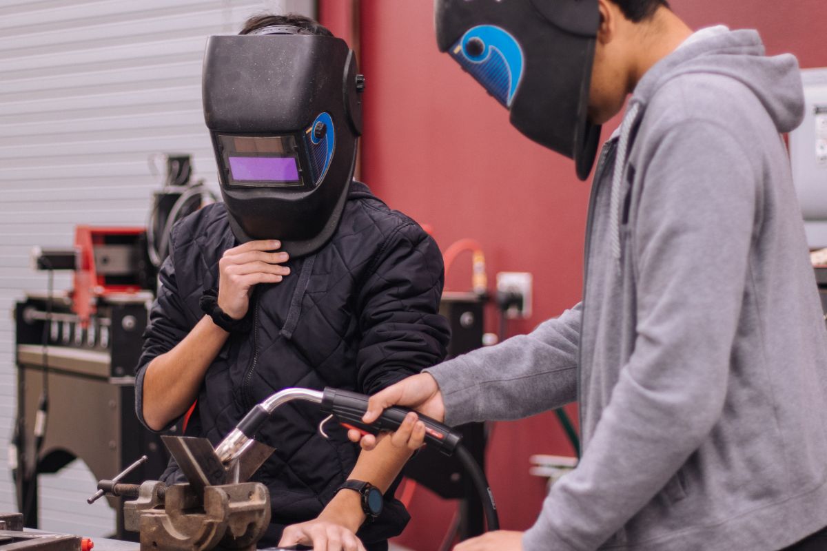 A picture of people welding. 