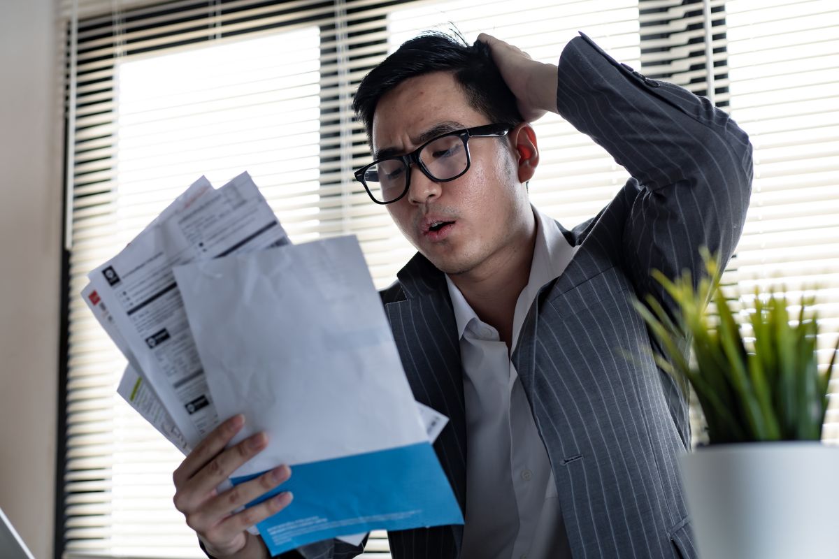 A picture of someone with many bills to pay.