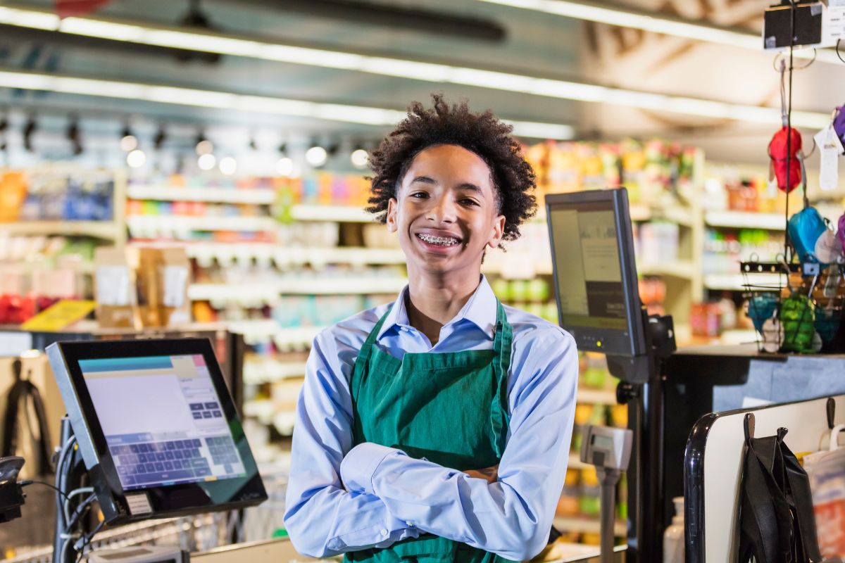 A picture of a teenager working in a store. 