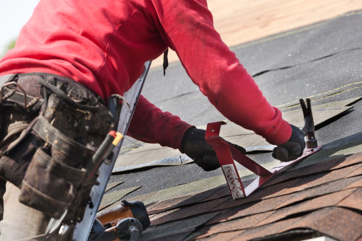 A picture of someone repairing a roof.