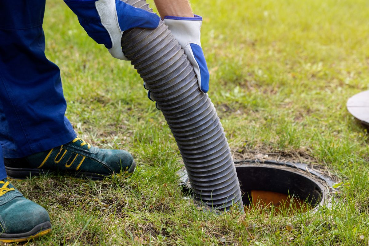 A picture of someone cleaning up a septic tank. 
