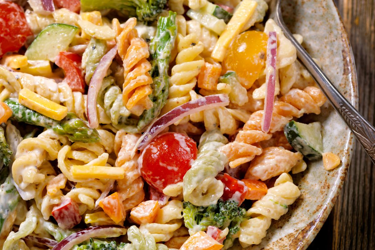 A picture of Pasta salad with garden veggies.
