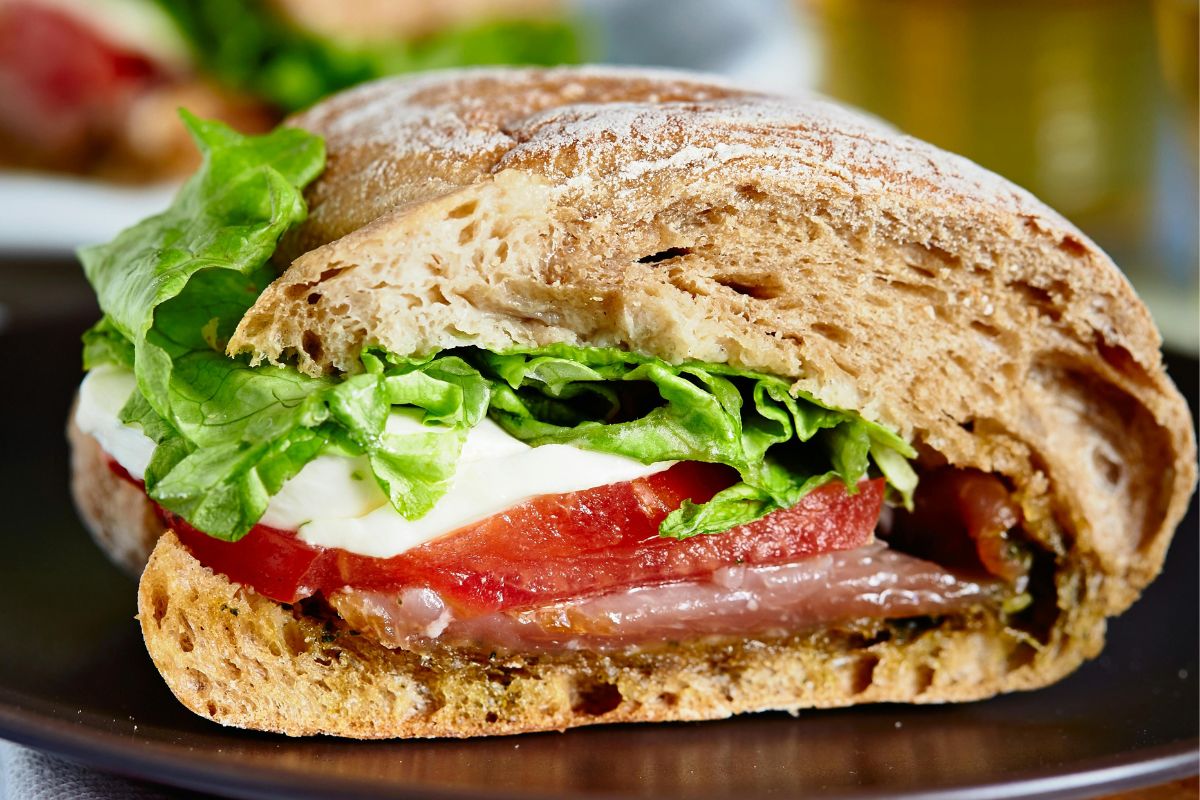 A picture of a Caprese-style tomato and mozzarella sandwich.