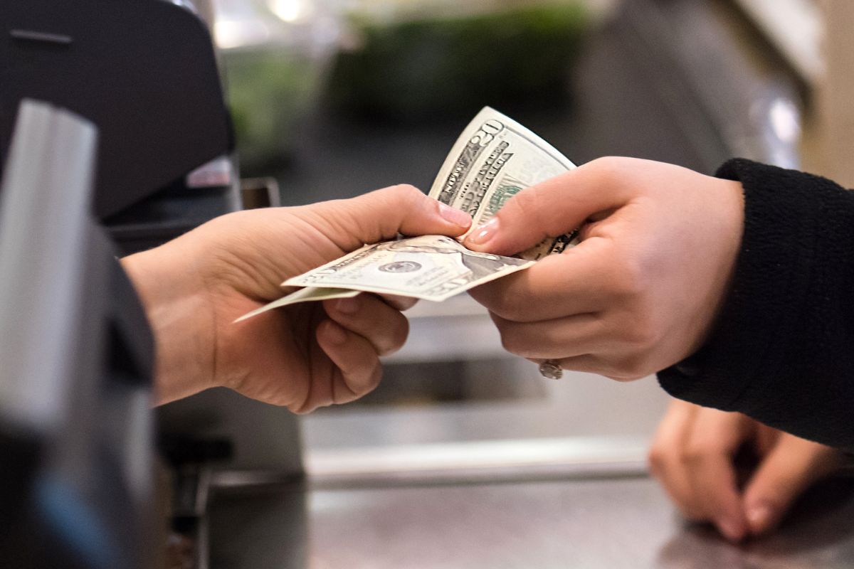 A picture of someone paying cash.
