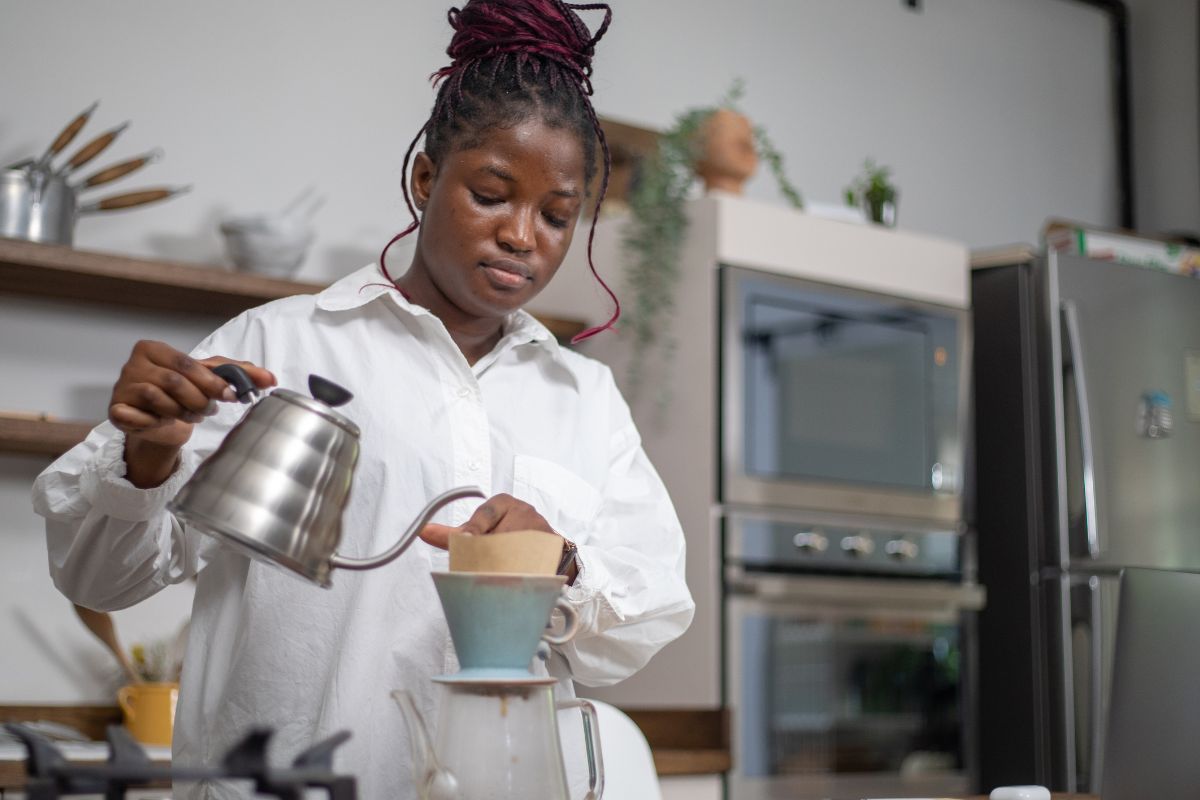 A picture of someone making coffee.