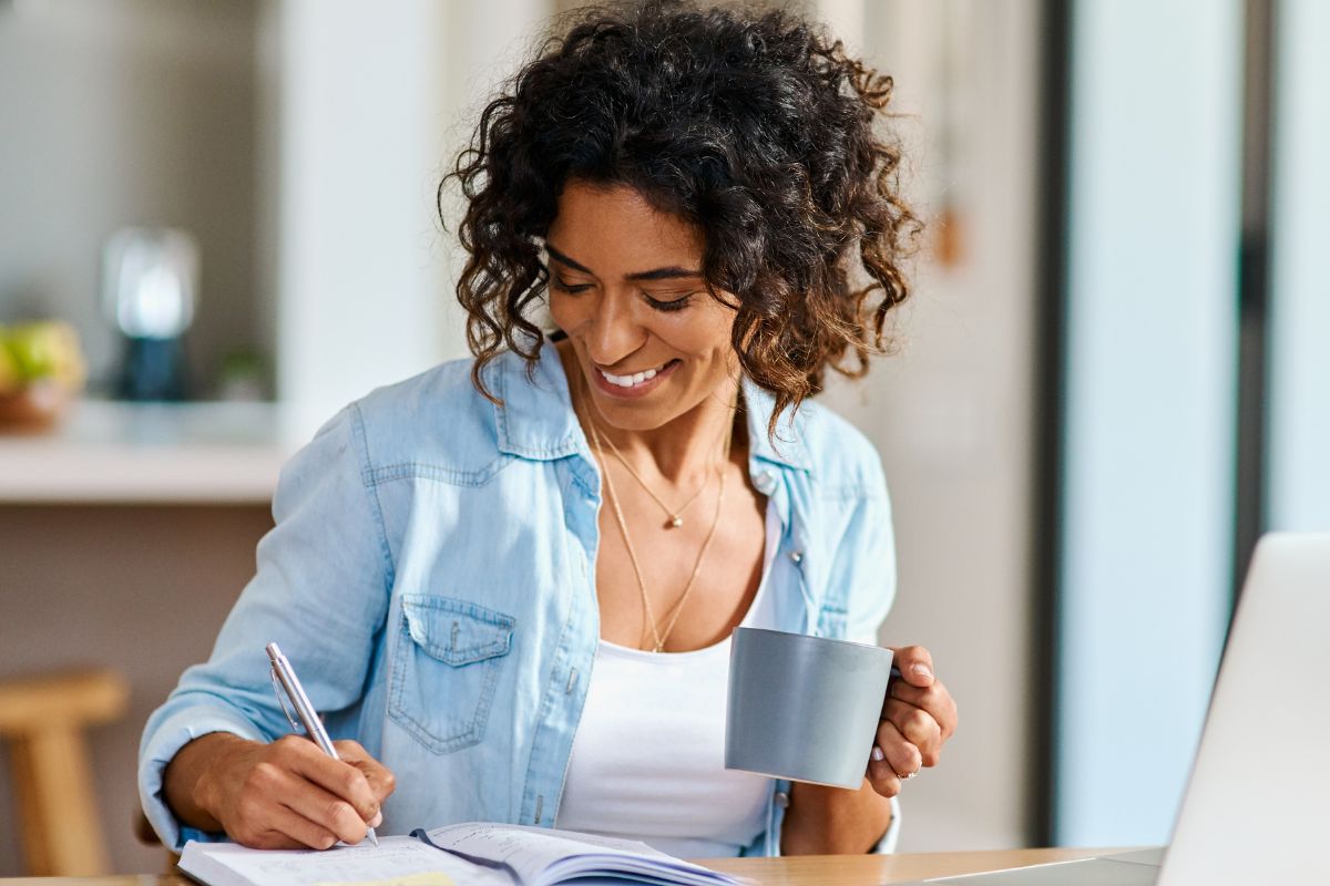 A picture of someone writing down something. 