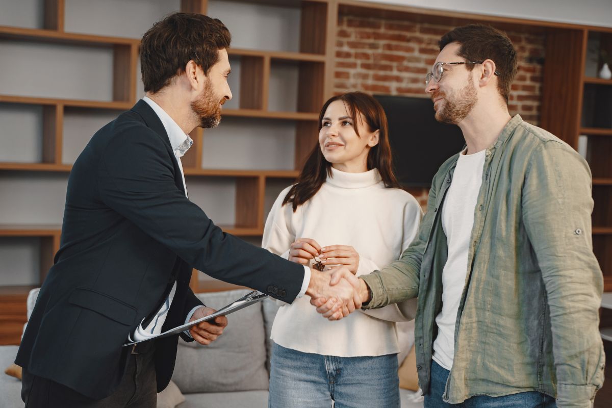 A picture of a couple talking with an agent. 