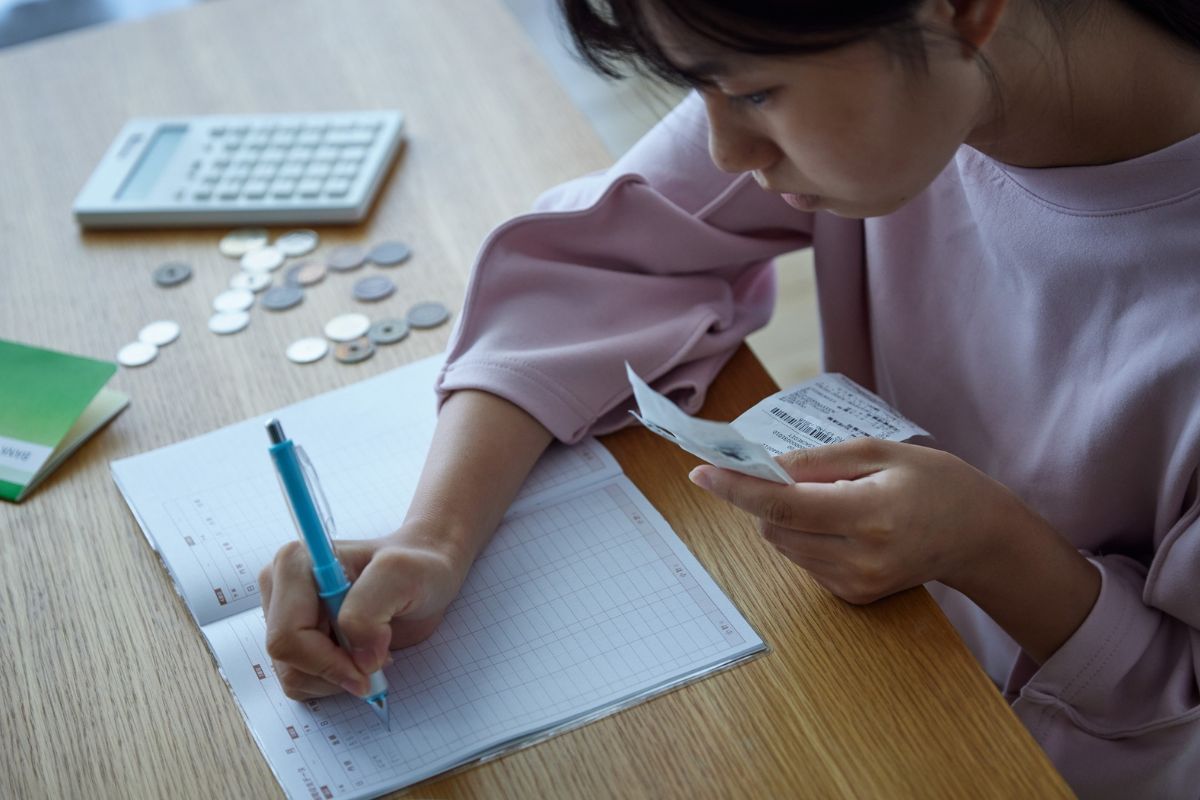 A picture of someone writing something down. 