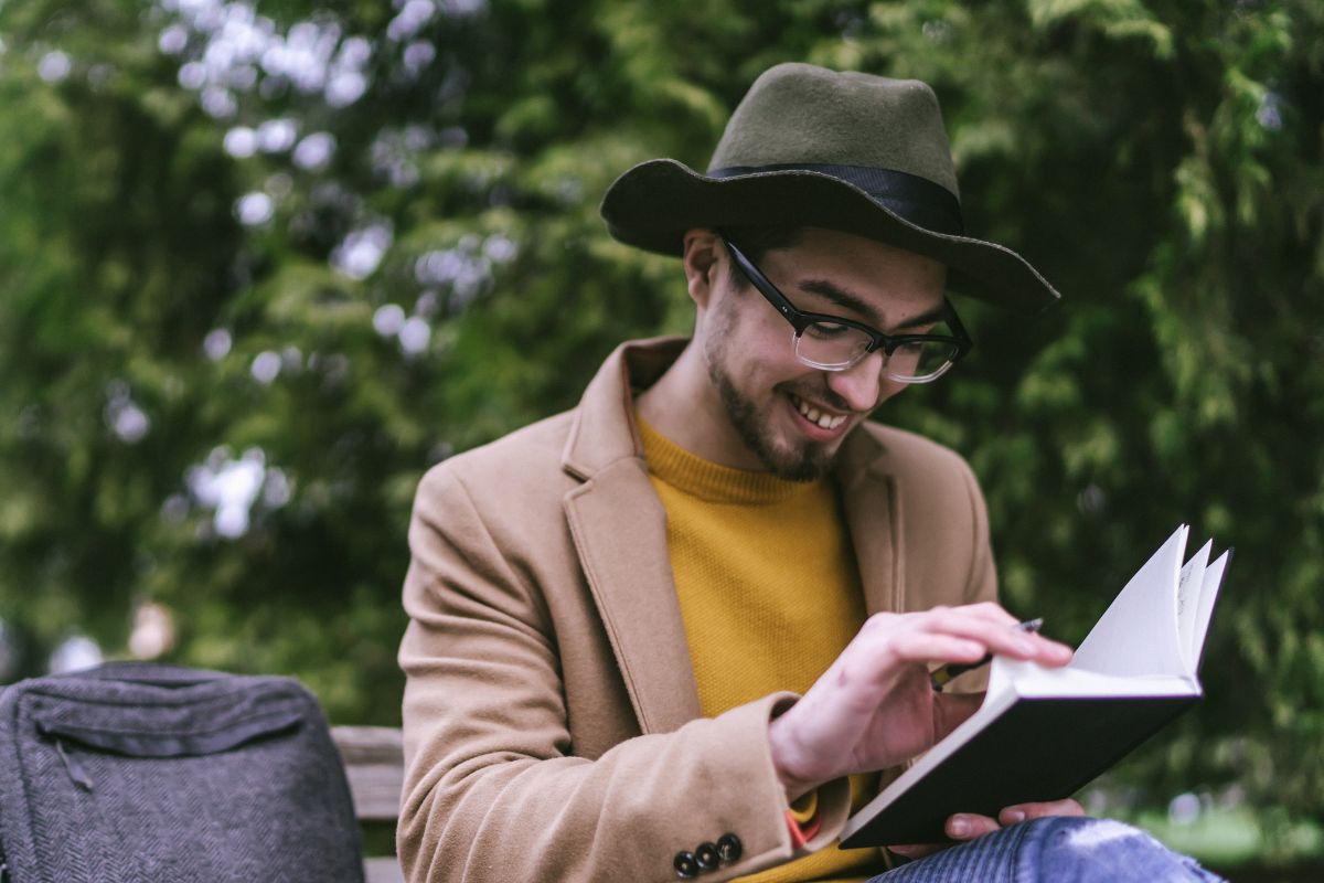 A picture of someone smiling while writing. 