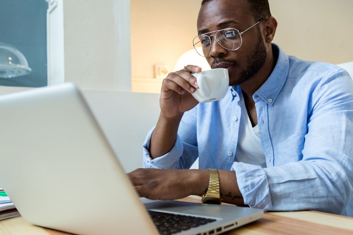 A picture of someone looking at his laptop. 