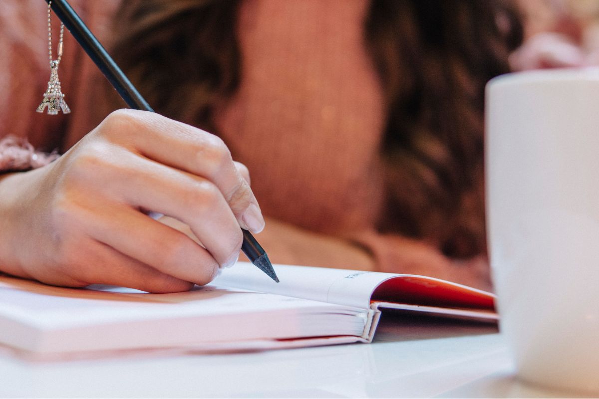 A picture of someone writing. 