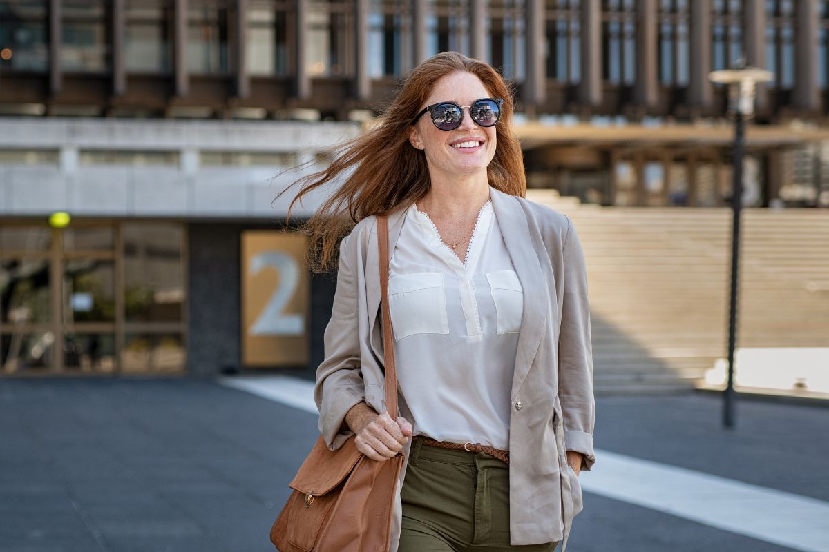 A picture of someone smiling while walking. 