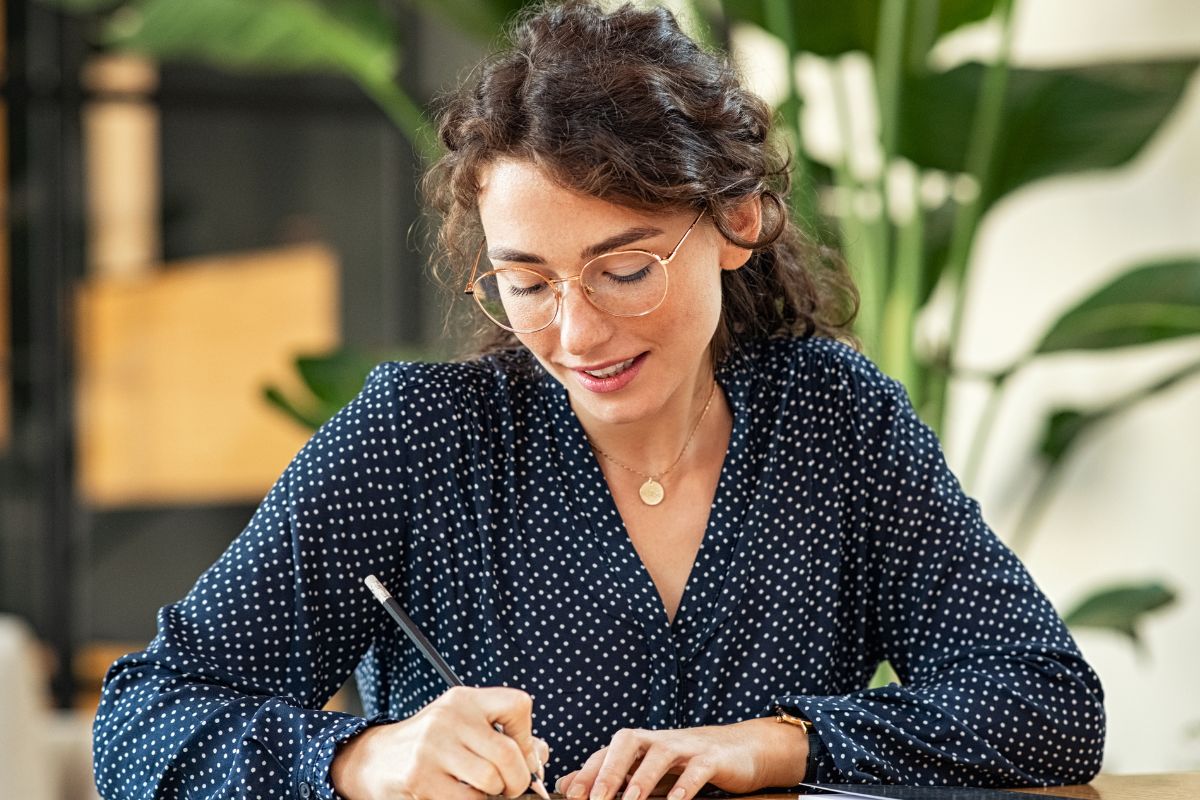 A picture of someone writing something down. 