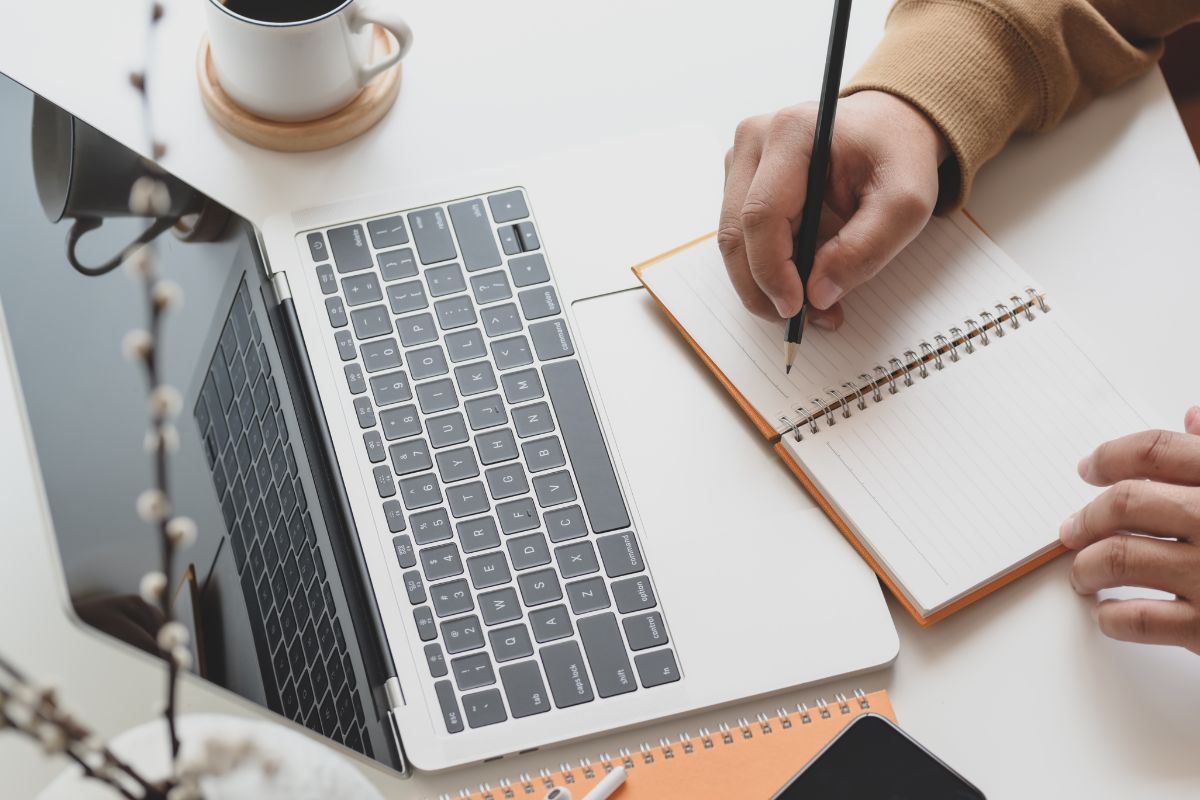 A picture of someone writing something down. 