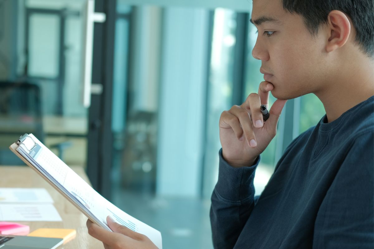 A picture of someone looking at papers seriously. 