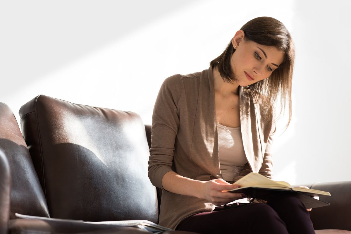 A picture of someone looking at her notebook.