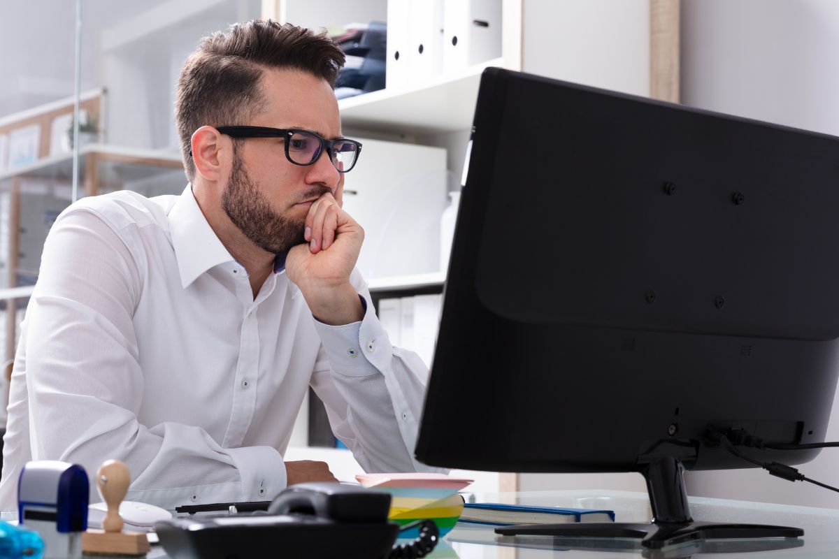 A picture of someone looking at his laptop.