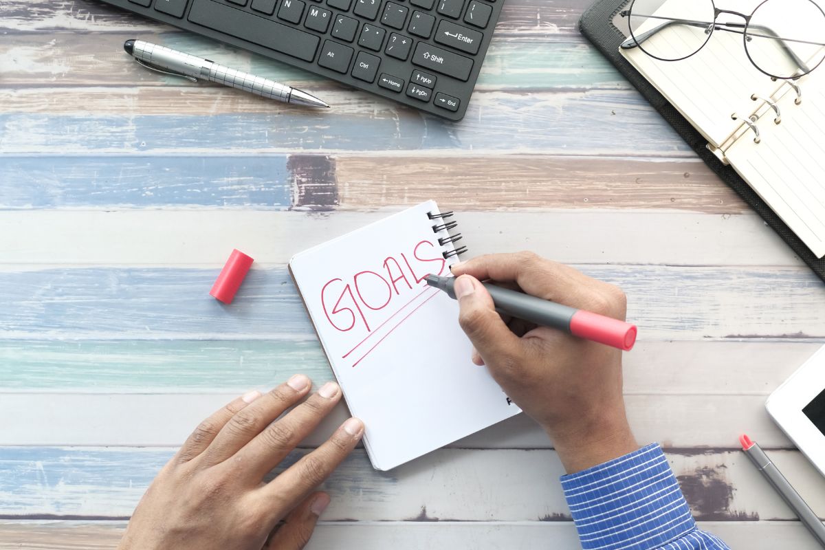 A picture of someone writing their goals. 