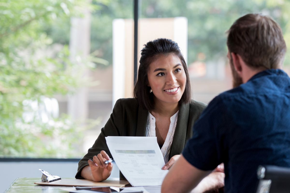 A picture of an agent talking to a client.