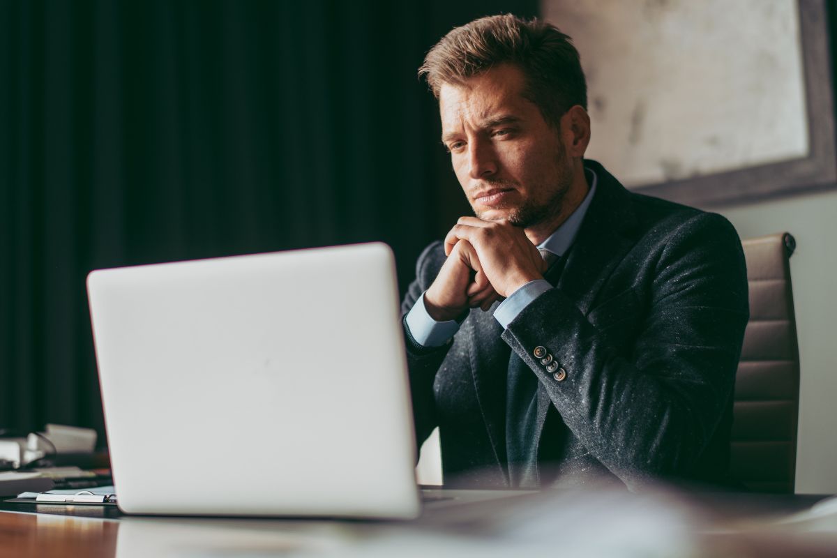 A picture of someone looking at his laptop. 