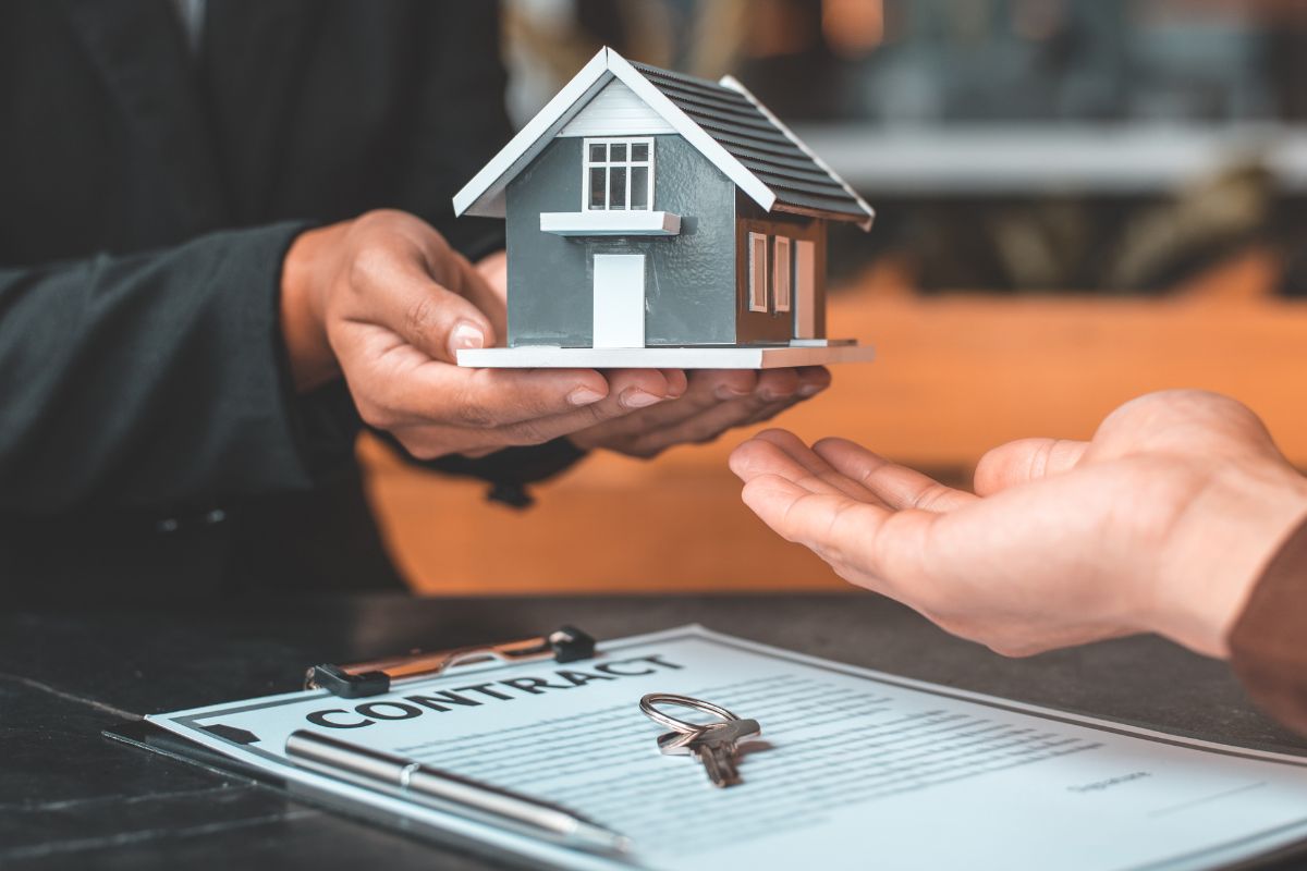 A picture of someone paying for a house. 