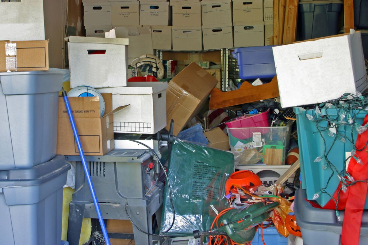 A picture of someone cleaning out a garage. 