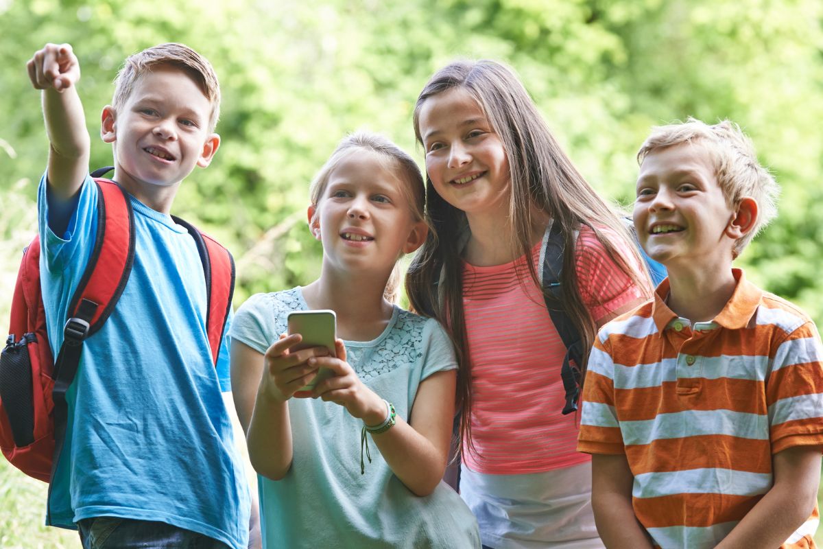 A picture of kids doing geocaching. 