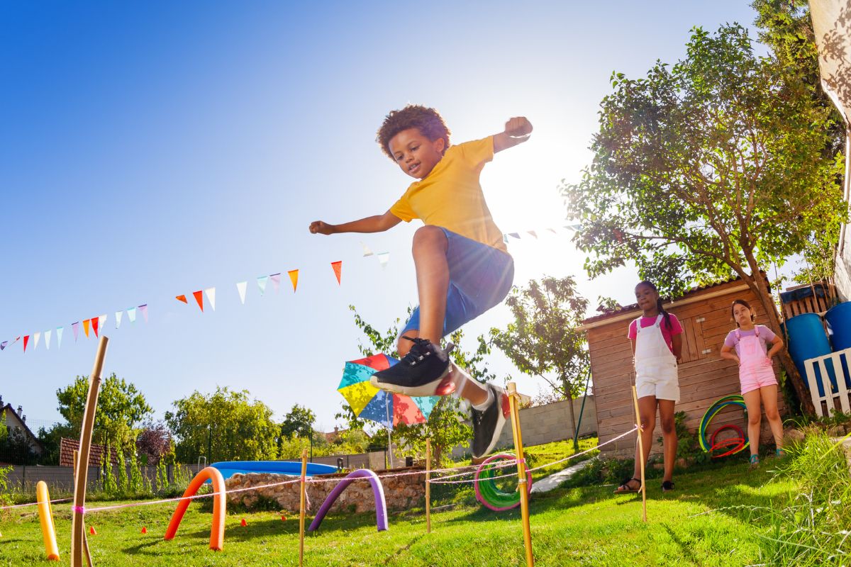 A picture of a child doing a backyard obstacle course. 