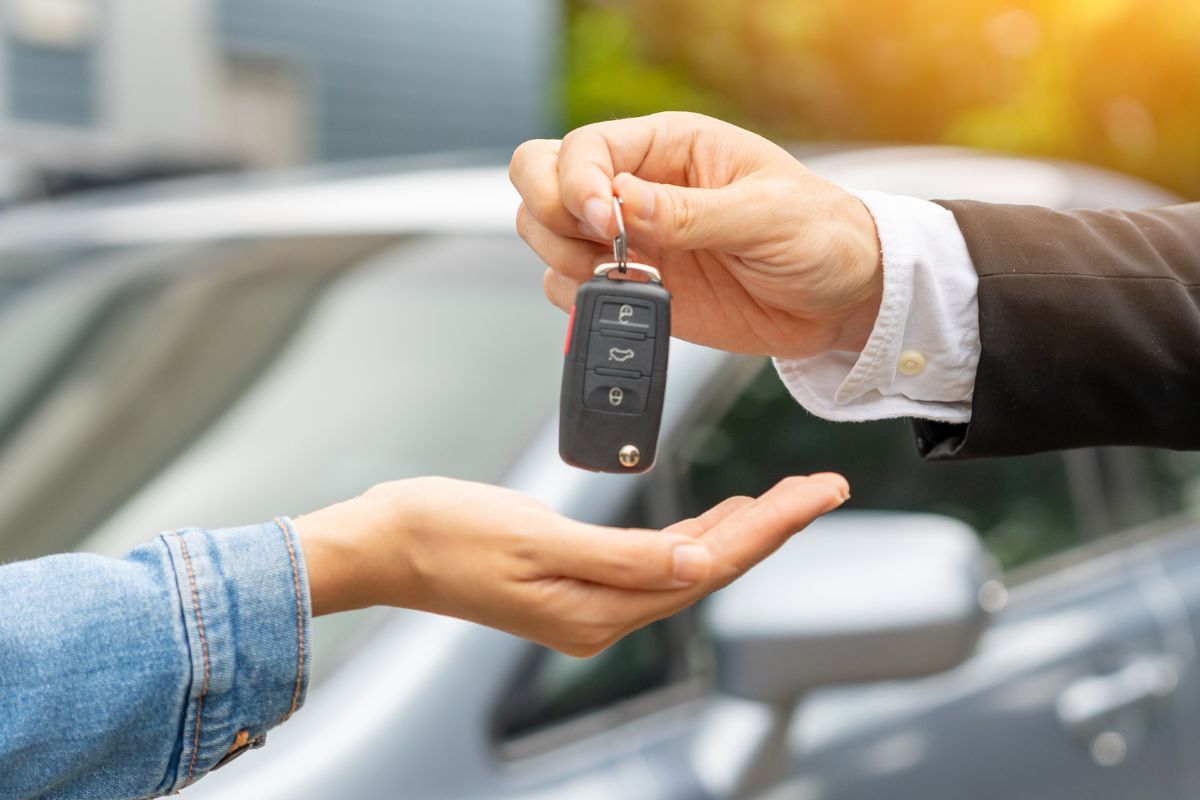 A picture of someone giving car keys. 