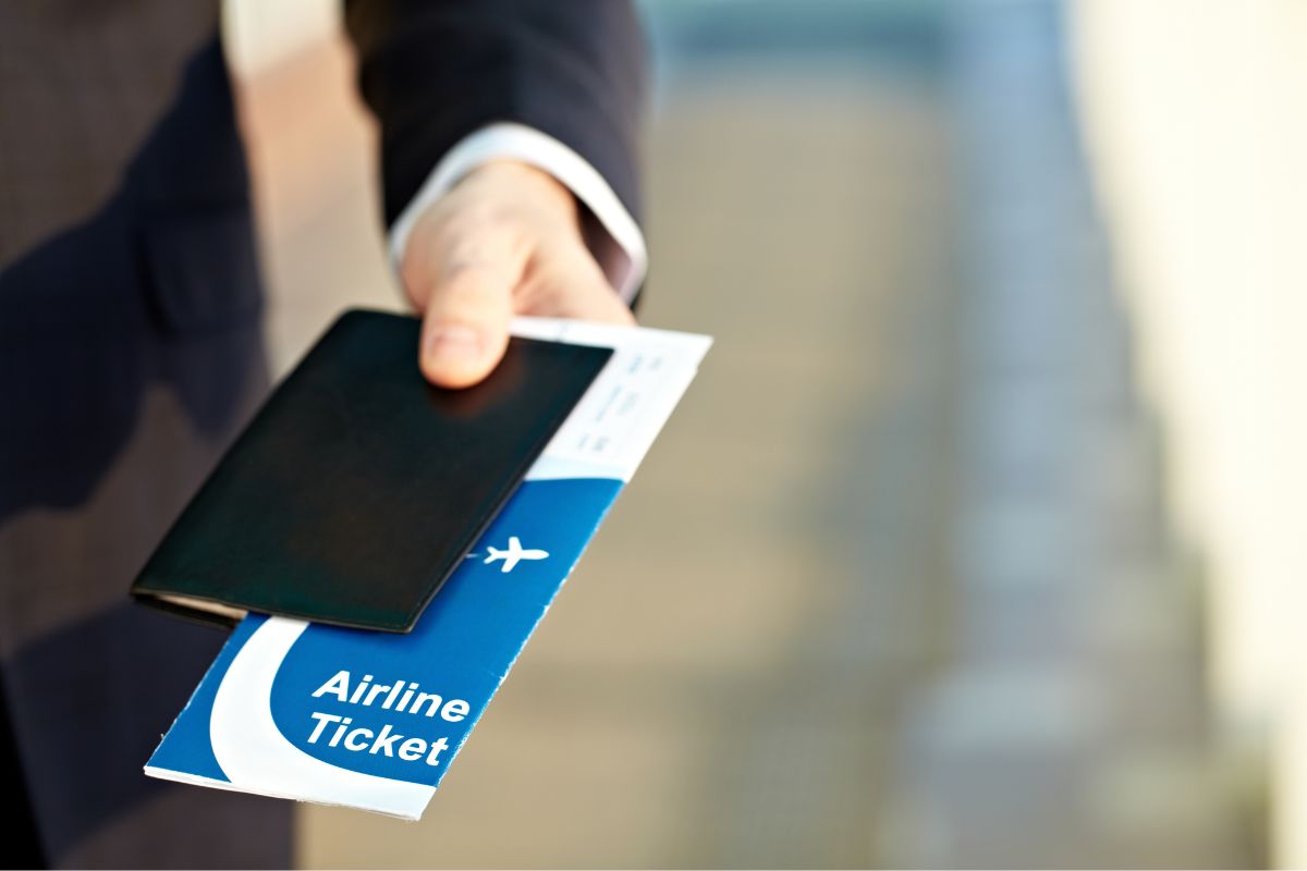 A picture of someone giving one's ticket and passport.