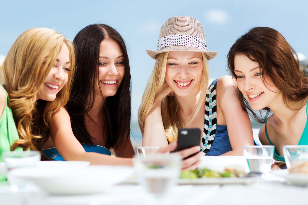 A picture of ladies looking at one's phone. 